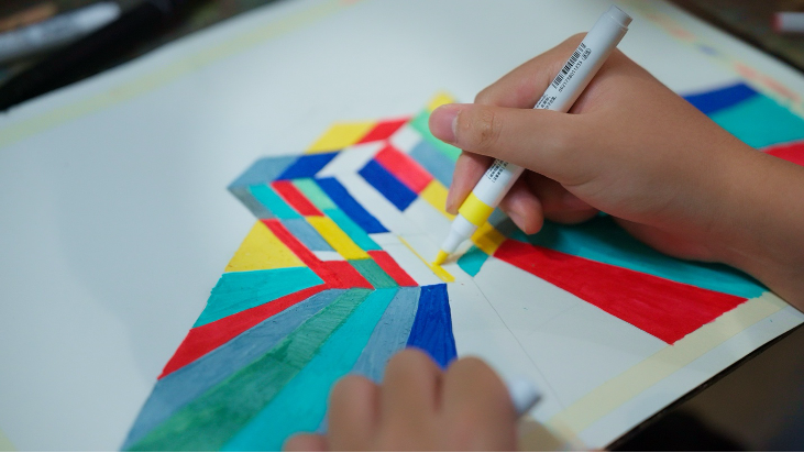 Title: A close-up of a person drawing
AI-generated content may be incorrect.
